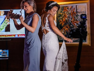 Bride and Maid of Honor standing on a 360 video booth