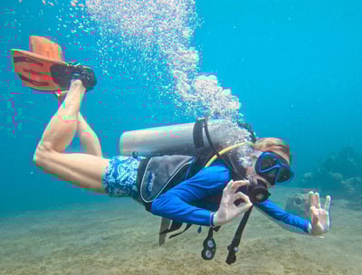 Female Scuba Diver in the water signaling ok, feeling safe