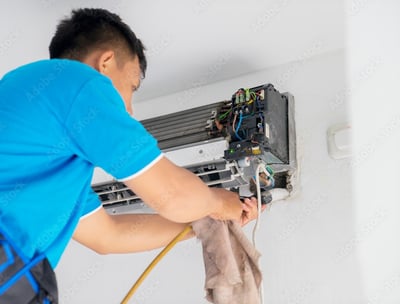 Air Condition Technician Servicing an Aircon Unit System