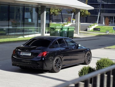 a black car parked on a street corner