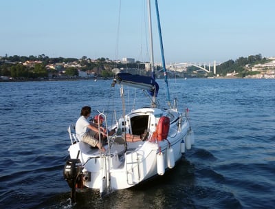 Our sailboat Monark cruising on the Douro River on a sunny day