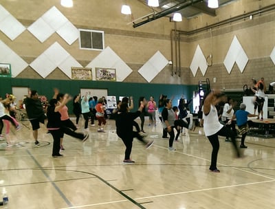 Enhancing Forward Action image of a group of people doing zumba.