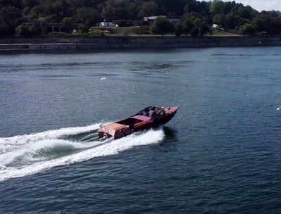 Guests enjoying a James Bond–style ride on Eskrok, a classic speedboat on the Douro River