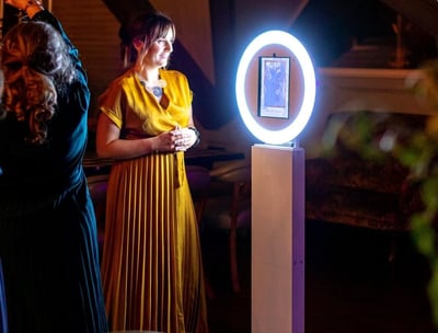 Photo Booth Rental attendant standing in front of a photo booth