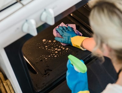 Lady cleaning oven