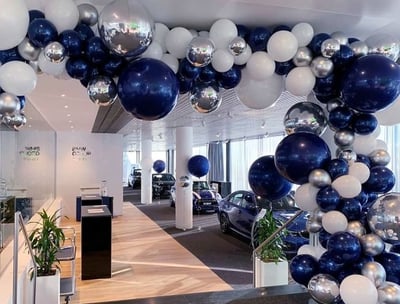 a car dealership with balloons and balloons