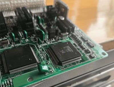 Close-up of car key programming device with electronic panel and diagnostic interface used by automotive locksmiths