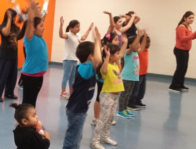 Enhancing Forward Action image of a group of children excising.