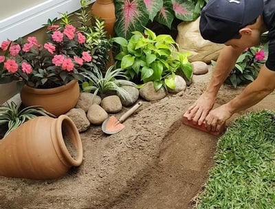 a man is kneeling down in a garden