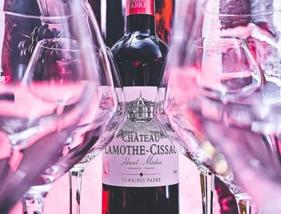 a bottle of wine with a bottle of wine in front of a wine glass