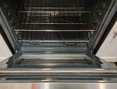 Immaculately cleaned oven interior showing polished racks and a grease-free surface.