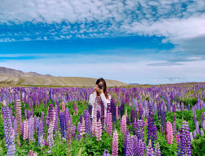 a woman standing in a field of flowers