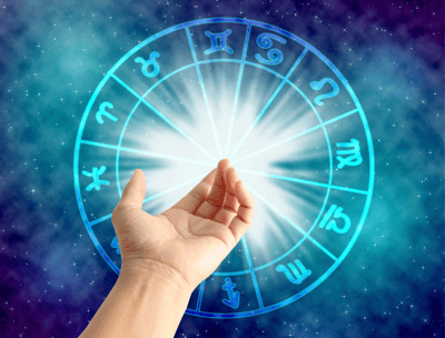 a person holding a circle of astrological signs
