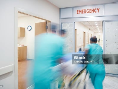 a group of medical workers walking through a hospital