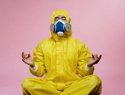 a man in a yellow raincoat and a gas mask