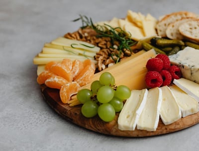a platter of cheeses and fruit