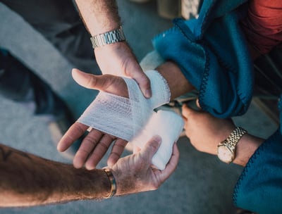 a man is holding a bandage in his hand