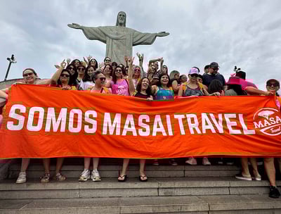 a group of people standing on steps with a large banner