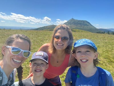 a family of three smiling and posing for a photo