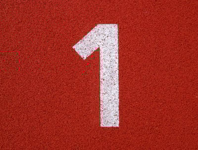 a number one on a red surface of a tennis court