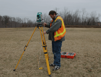 a man in a safety vest and a tripodod