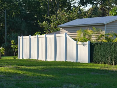 a fenced in area with a fence and a motorcycle