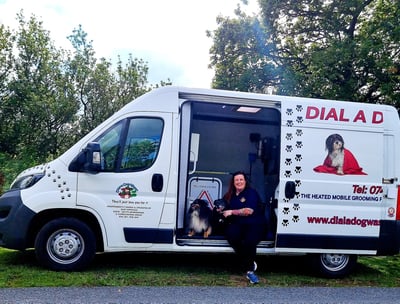 Suzy with her dog inside the custom build dial a dog wash van