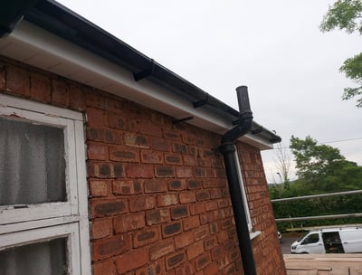 Picture of fascia , soffit and gutter on house in white and black