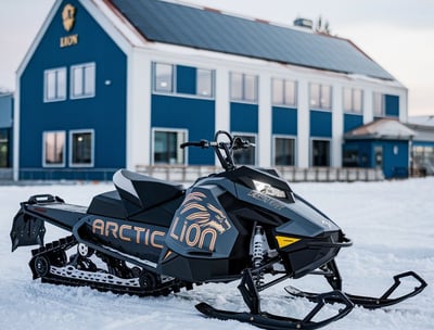 a snowmobile parked in front of a blue house