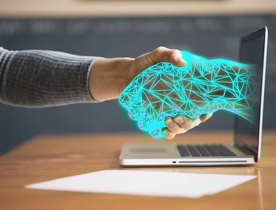 a person shaking hands with a laptop