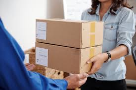 a woman is holding a box of boxes