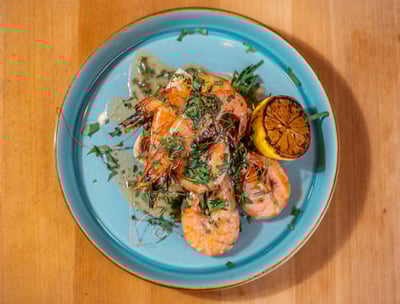 King prawns on a blue plate with lemon