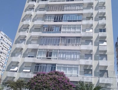 a tall building with a bunch of windows and a tree