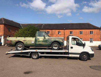 a truck with a flat bed and a pickup truck