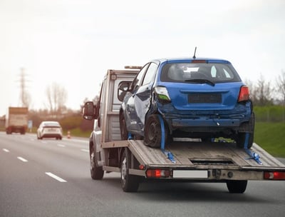 a tow truck with a flat bed and a car