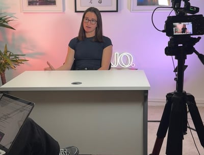 a woman sitting at a desk working on content creation