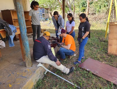 C.J. is teaching a group of students about safely measuring battery voltage. 