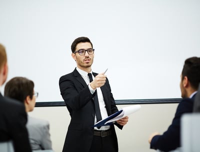 A man is teaching others depicting good body language and confidence 