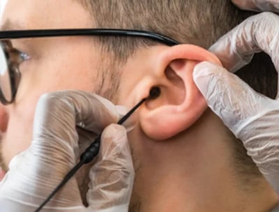 a man having earwax removed with a Jobson Horne probe