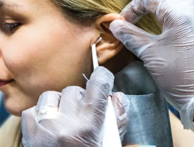 a woman having earwax removed with Water Irrigation