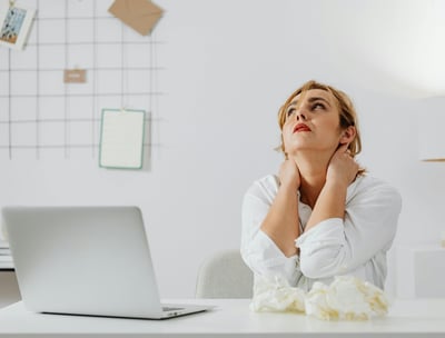 a woman sitting at a desk with a laptop computer