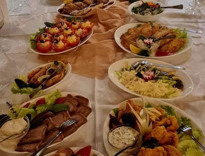 a long table with plates of food and glasses