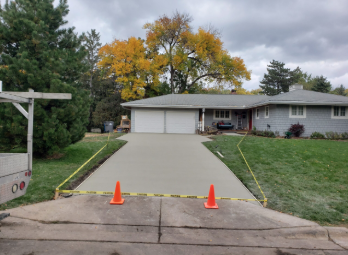 a driveway with orange cones and orange cones