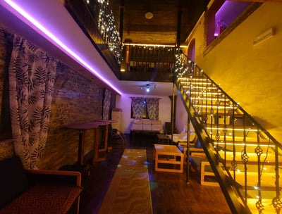 a room with a staircase and a couch