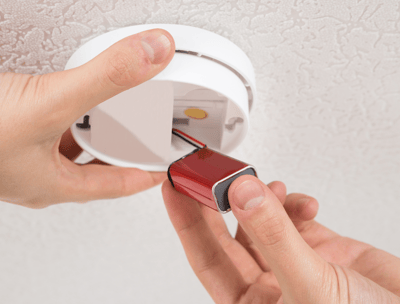 smoke alarm battery being replaced