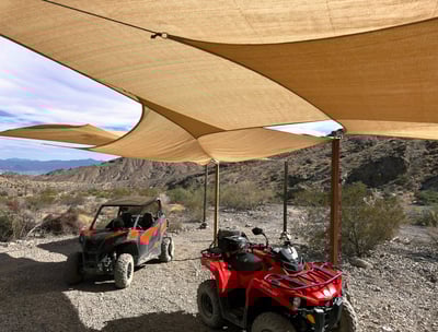 two atvs parked in a desert area