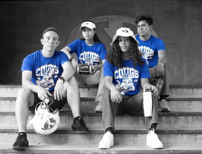 a group of people sitting on steps with a soccer ball