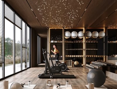 a woman in a gym room with a variety of exercise equipment