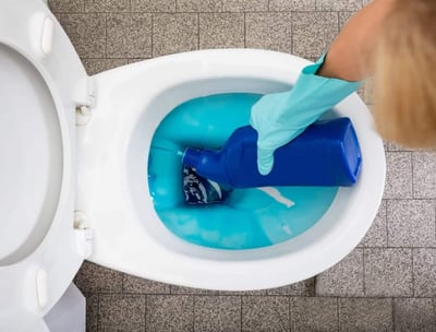 overused wasted liquid toilet cleaner creating a messy toilet