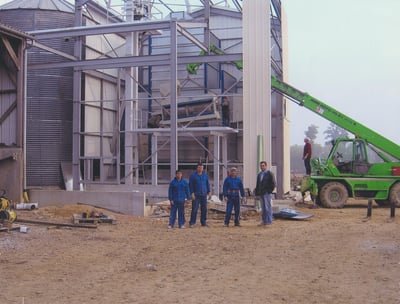 a group of people standing around a construction site